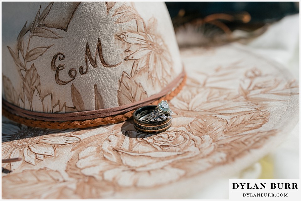 2nd chance at love rocky mountain elopement wedding details cowboy hat and wedding rings