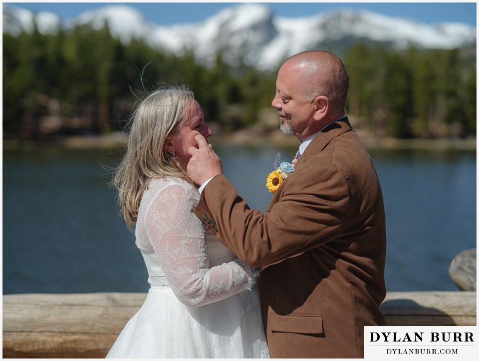 2nd chance at love rocky mountain elopement groom wiping away happy tears