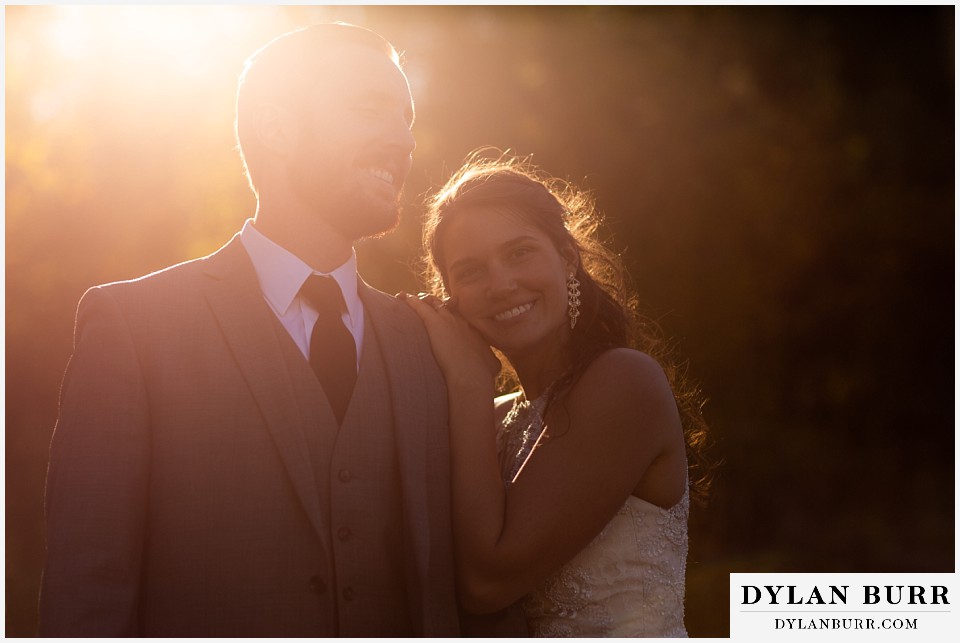 rocky mountain national park elopement wedding bride and groom standing in sunset