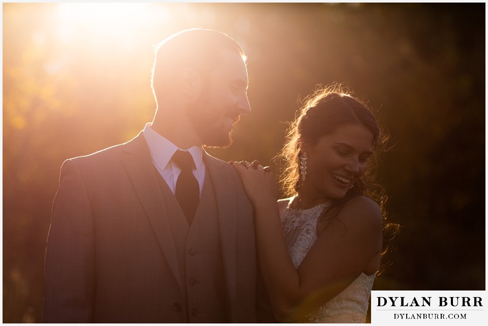 rocky mountain national park elopement wedding bride and groom standing in sunlight