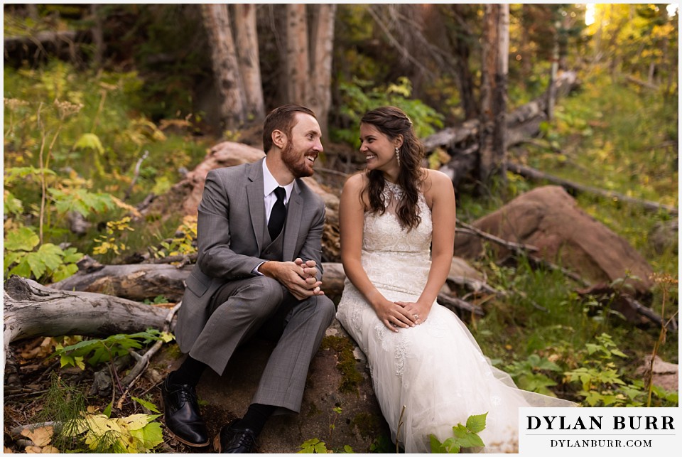 rocky mountain national park elopement wedding couple laughing together in forest