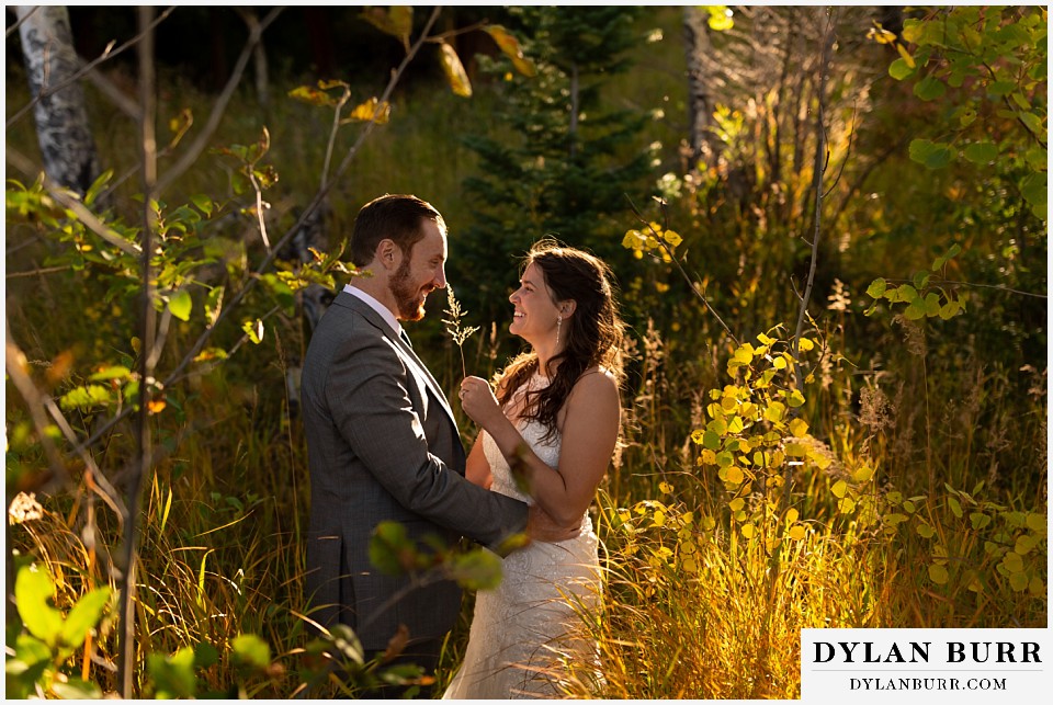 rocky mountain national park elopement wedding bride tickling husband with grass