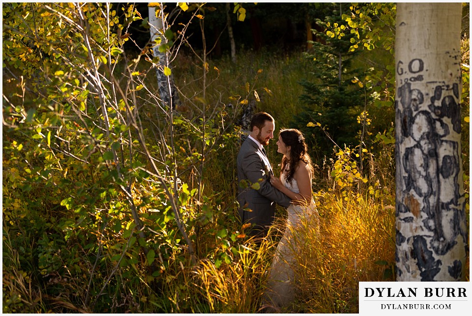 rocky mountain national park elopement wedding couple laughing together in sunlight