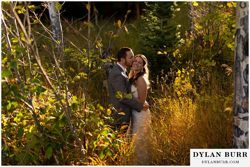 rocky mountain national park elopement wedding groom kissing bride on cheek