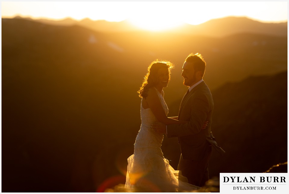 rocky mountain national park elopement wedding bride and groom laughing from the intense wind