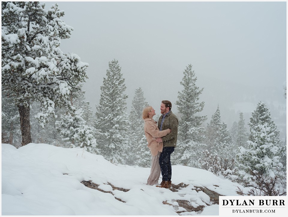 wedding proposal in the snow rocky mountain national park with pine trees