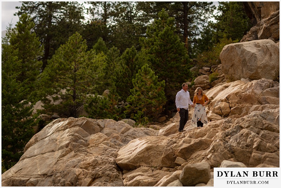 rocky mountain national park elopement wedding bride and groom hiking on mountain