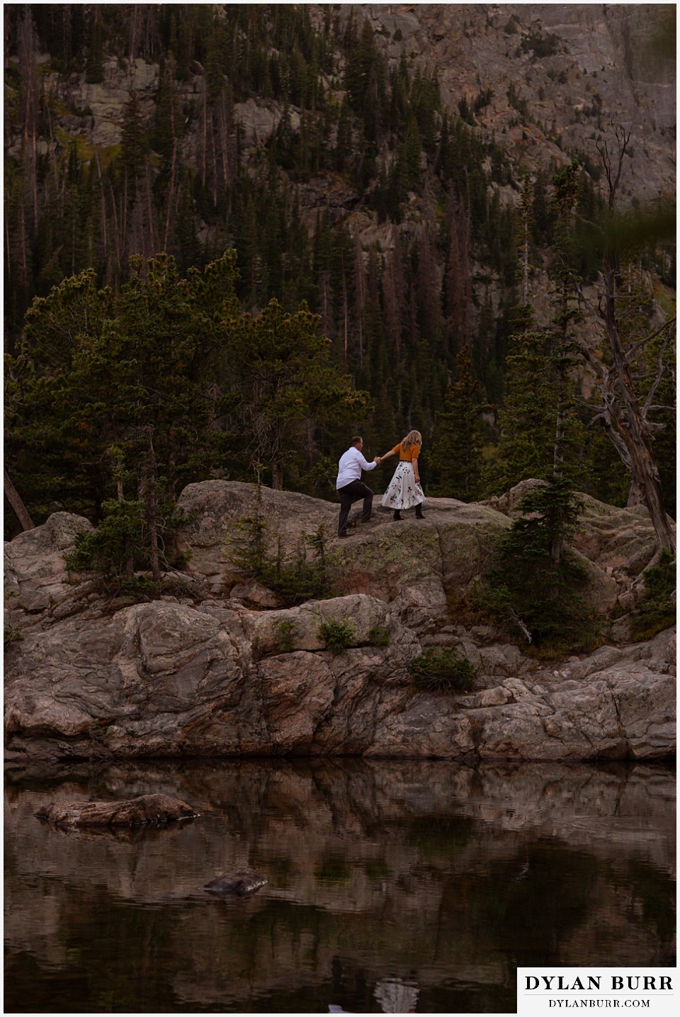 rocky mountain national park elopement wedding bride leads groom across rocks