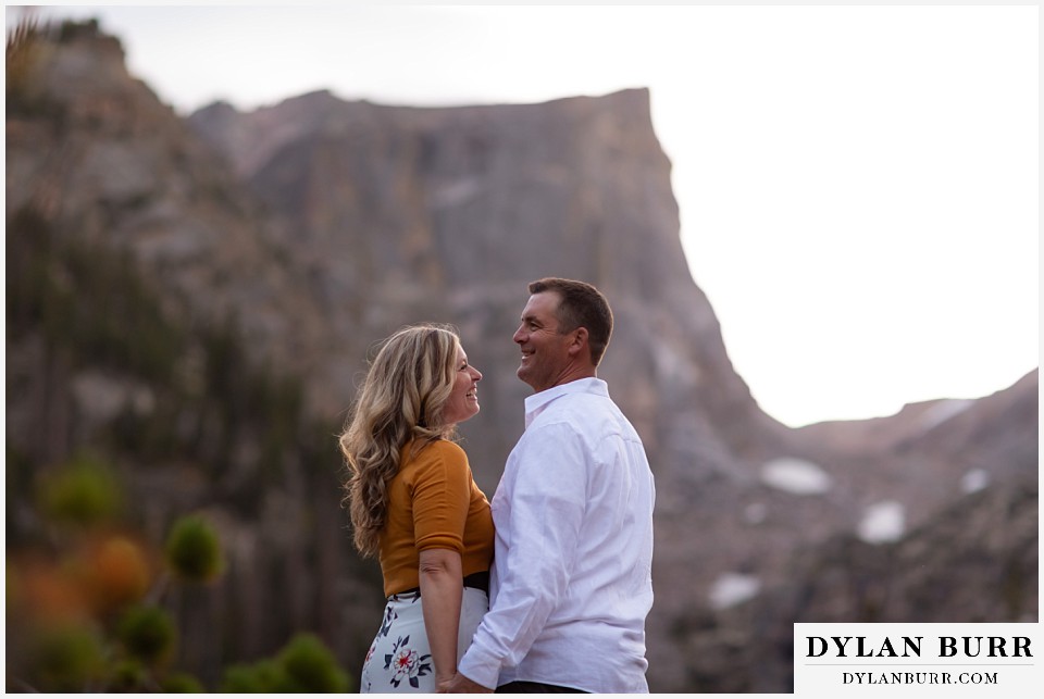 rocky mountain national park elopement wedding couple laughing at sunset with mountains in background