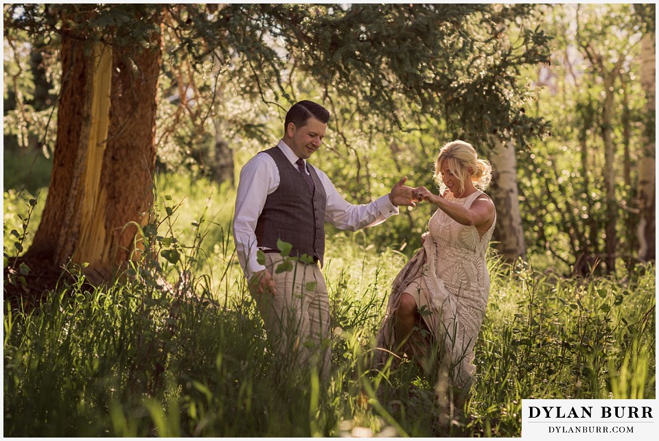 rocky mountain national park wedding elopement bride groom walking together down the mountain in tall grass