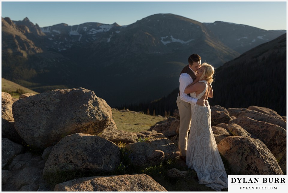 rocky mountain national park wedding elopement bride and groom sharing a mountain top kiss