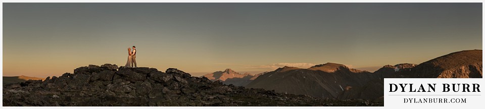 rocky mountain national park wedding elopement giant wide pano with bride and groom lit by sunset