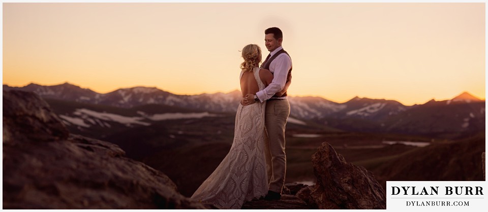 rocky mountain national park wedding elopement bride and groom on mountain top at sunset