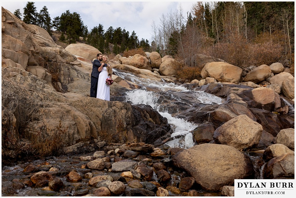 rocky mountain national park wedding elopement newly wed couple at waterfall in mountains
