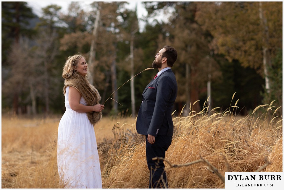 rocky mountain national park wedding elopement bride catches groom with her grass sword