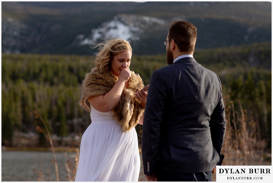 rocky mountain national park wedding elopement wife reading wedding vows to her husband in mountains