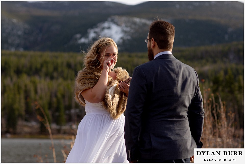 rocky mountain national park wedding elopement bride begins to cry while reading vows