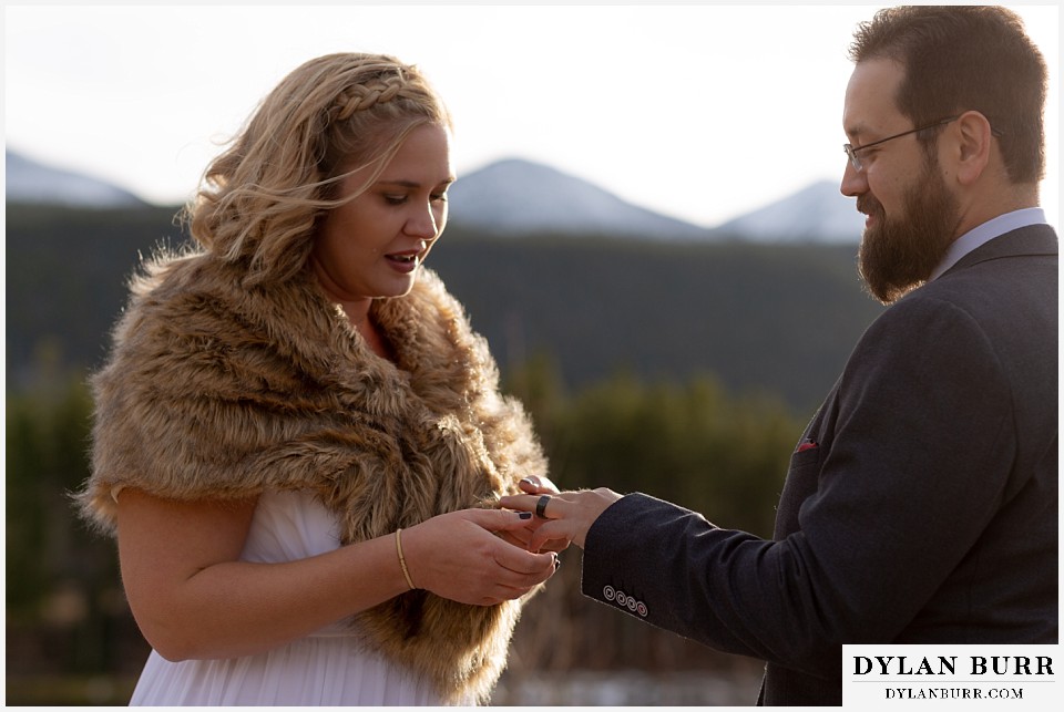 rocky mountain national park wedding elopement bride placing wedding ring on grooms finger
