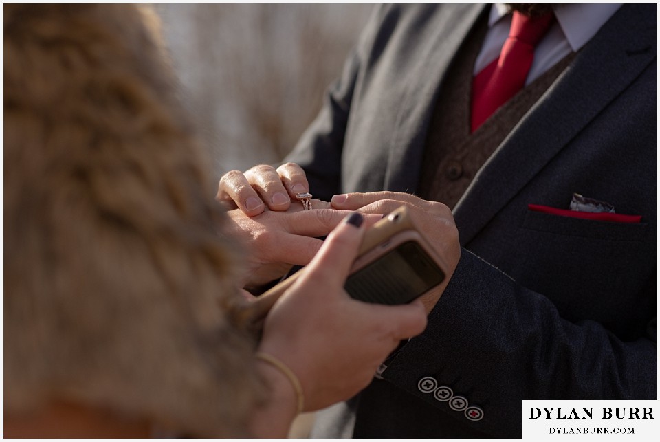 rocky mountain national park wedding elopement groom placing wedding ring on brides finger