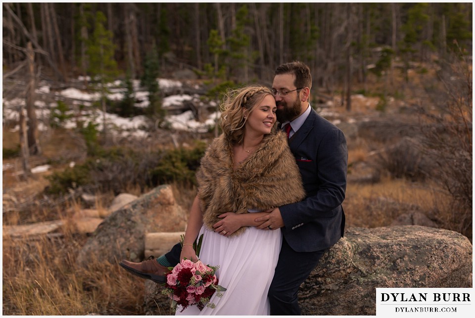 rocky mountain national park wedding elopement bride and groom in mountains with snow on the ground