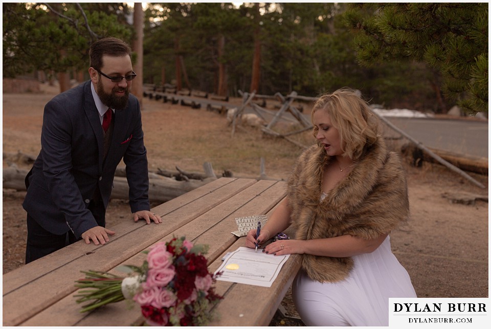 rocky mountain national park wedding elopement bride signing wedding certificate