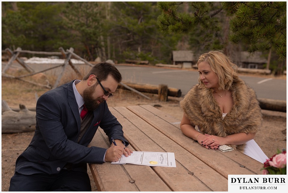 rocky mountain national park wedding elopement groom signing wedding certificate