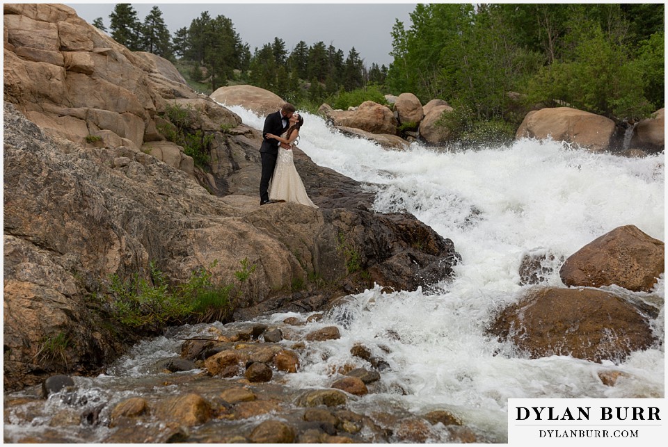rocky mountain national park wedding elopement colorado wedding photographer dylan burr bride and groom surrounded by giant waterfall