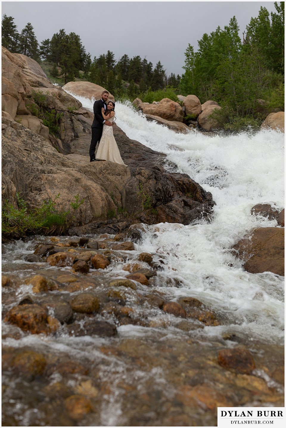rocky mountain national park wedding elopement colorado wedding photographer dylan burr bride and groom by giant waterfall and river