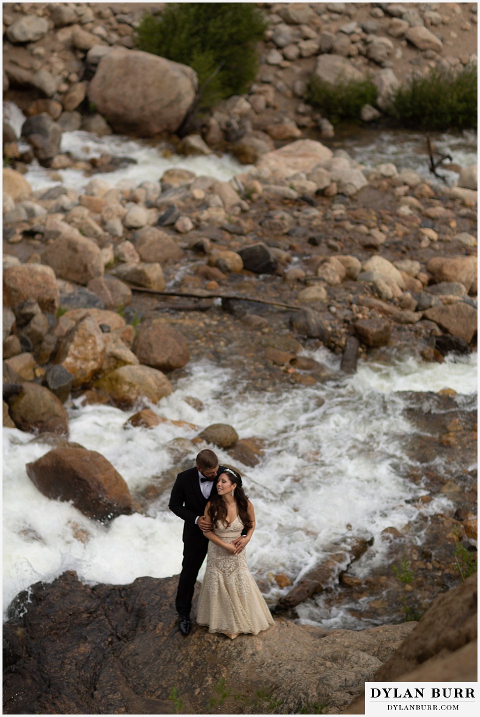rocky mountain national park wedding elopement colorado wedding photographer dylan burr looking down on bridal couple near river