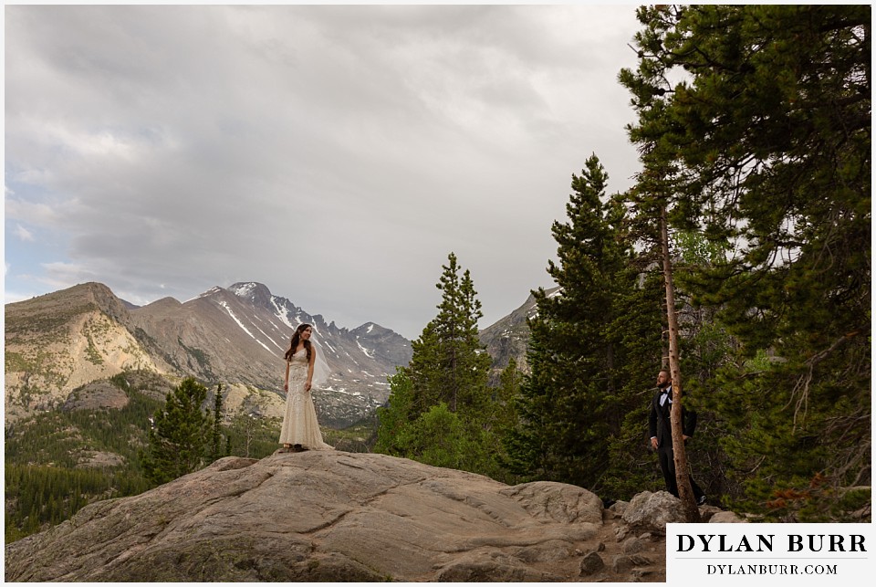rocky mountain national park wedding elopement colorado wedding photographer dylan burr groom looking on at bride on large rock