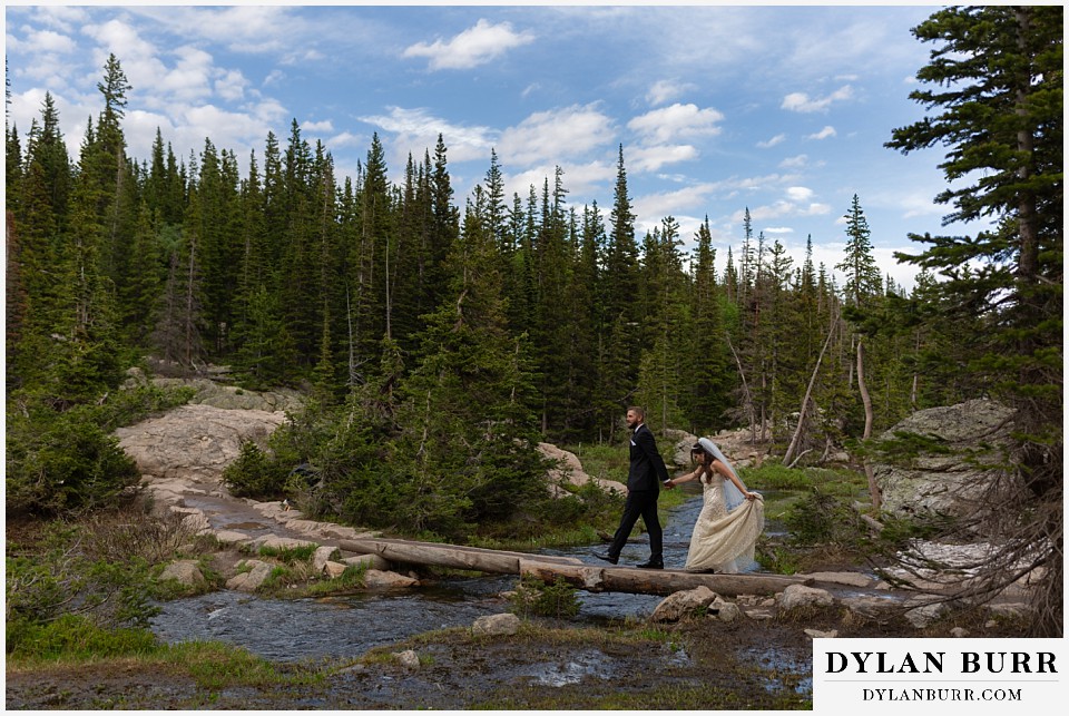 rocky mountain national park wedding elopement colorado wedding photographer dylan burr bride and groom walking across river