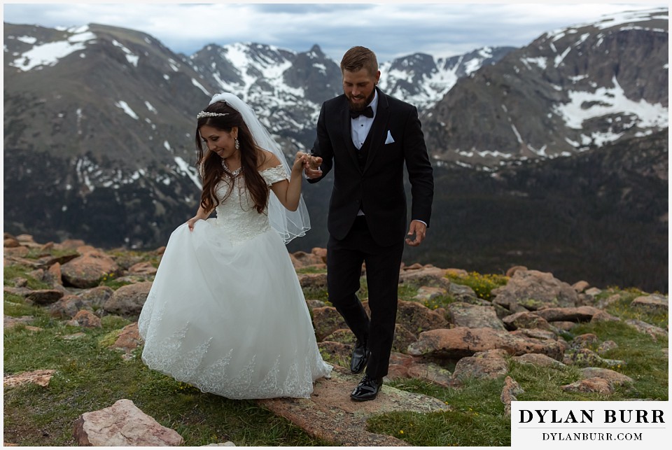 rocky mountain national park wedding elopement colorado wedding photographer dylan burr bride leading groom across rocks