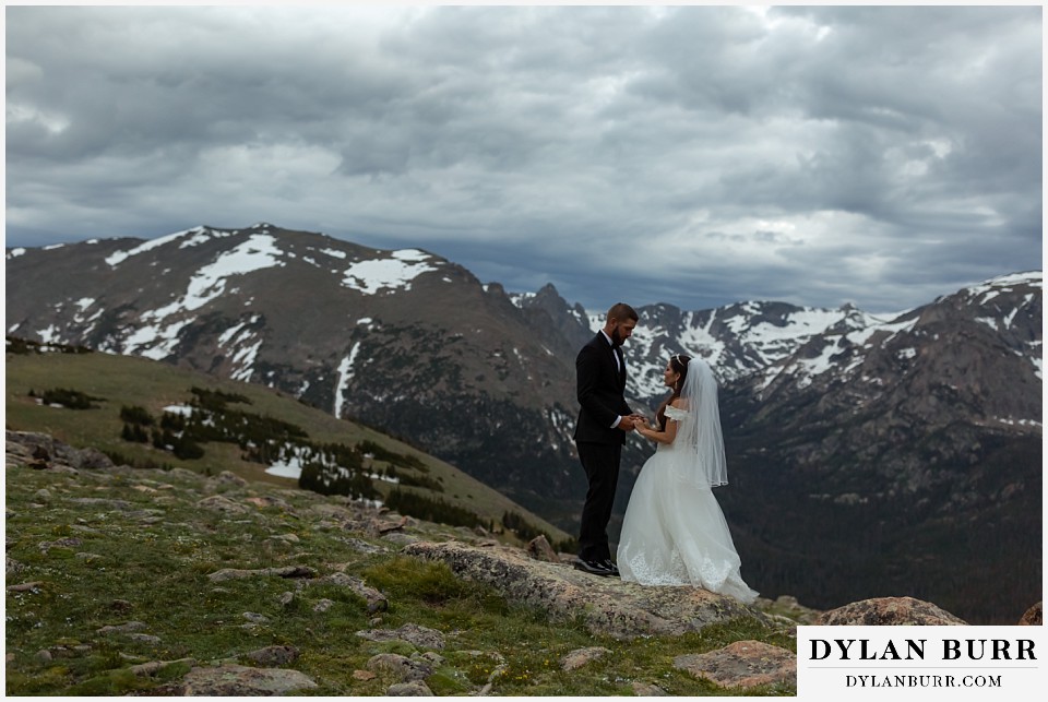 rocky mountain national park wedding elopement colorado wedding photographer dylan burr bride and groom together with huge mountain range