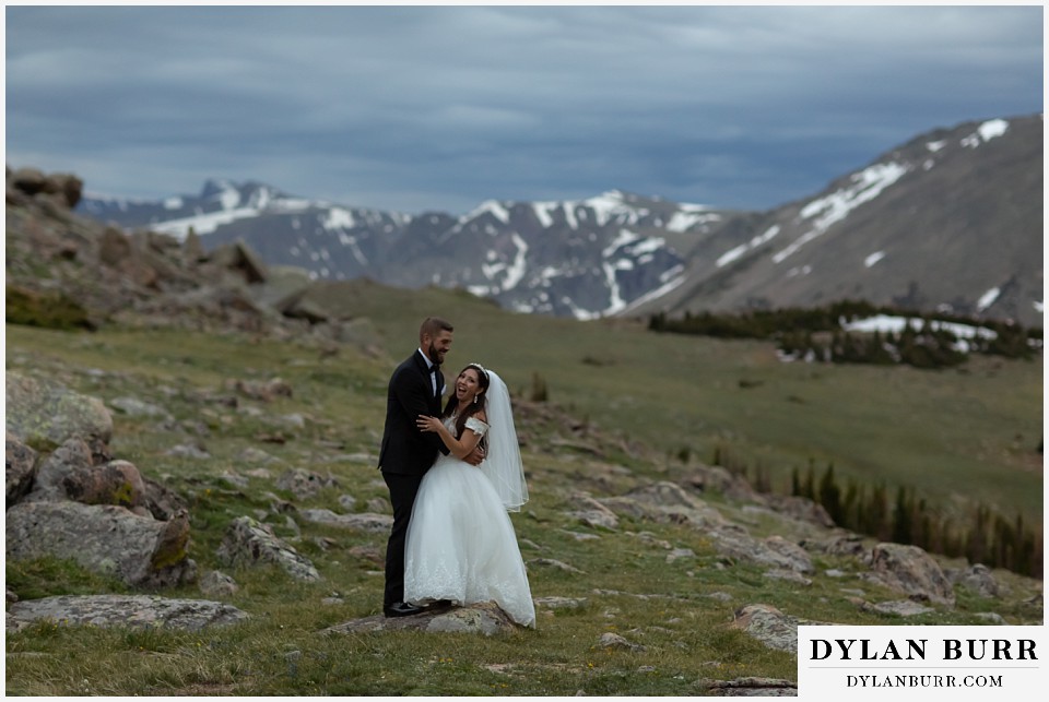 rocky mountain national park wedding elopement colorado wedding photographer dylan burr bride and groom laughing hard in mountains