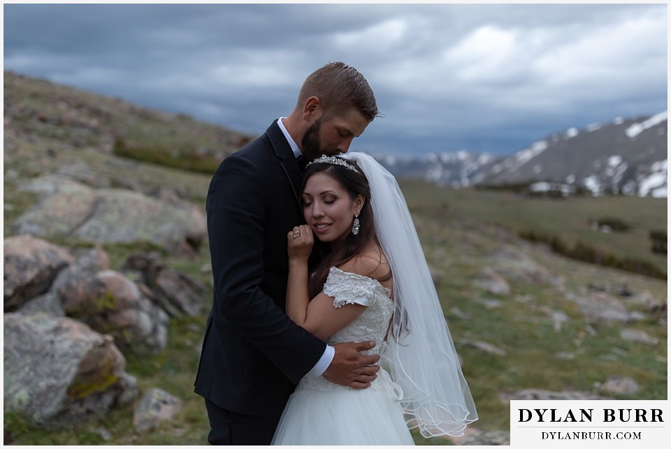 rocky mountain national park wedding elopement colorado wedding photographer dylan burr bride and groom snuggling in close