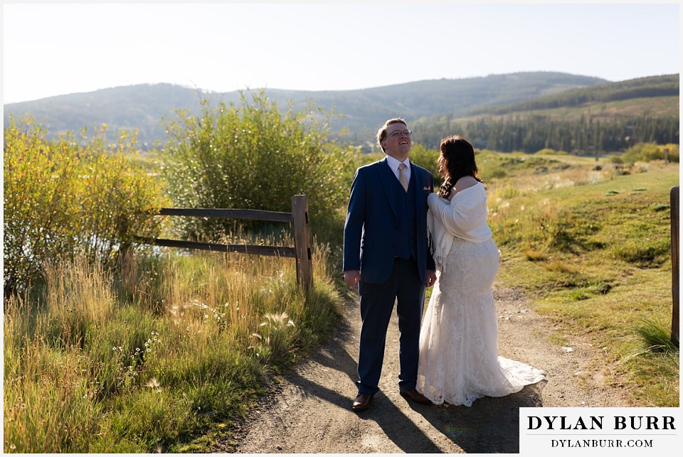 bride and groom laughing walking on path