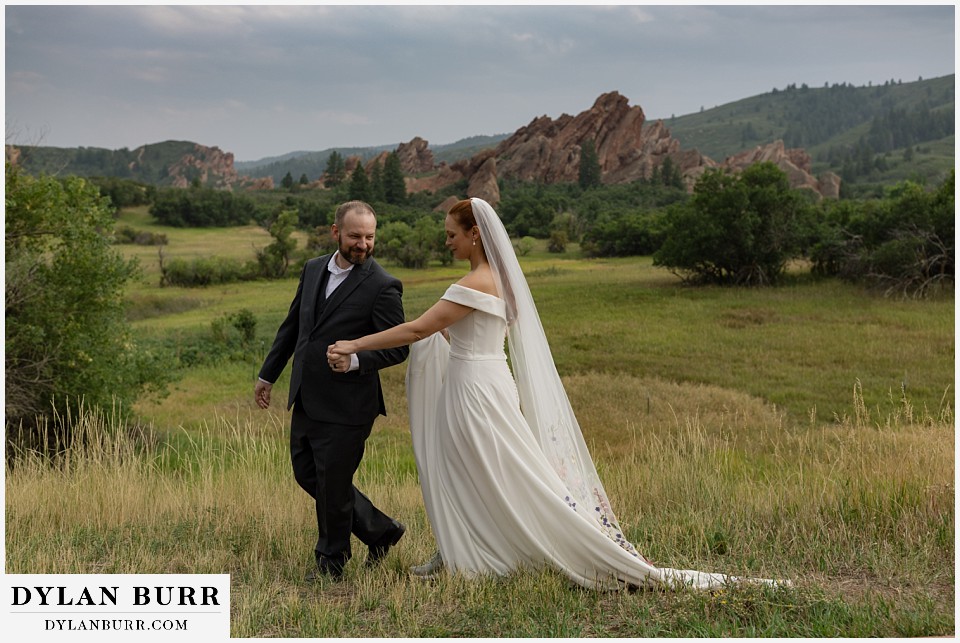 roxborough state park elopement wedding couple walking together with rocks in background