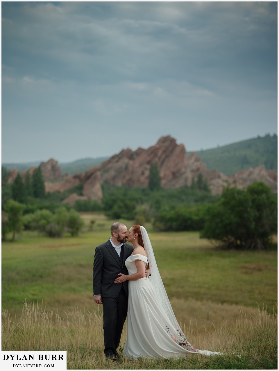 roxborough state park elopement wedding huge portrait of couple kissing in meadow
