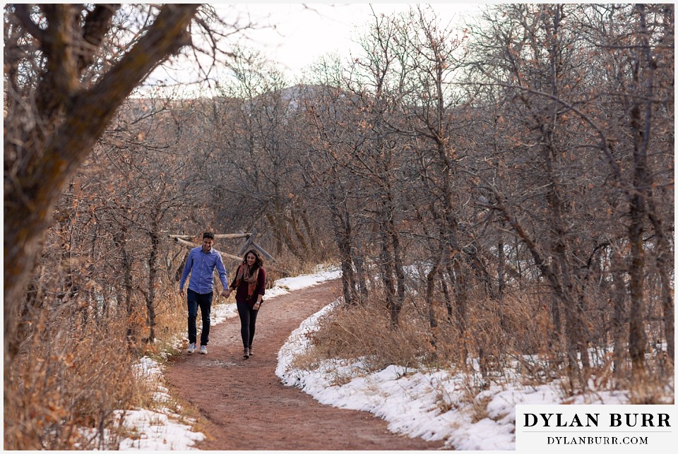 roxborough state park engagement photo session couple walking down path in oak trees