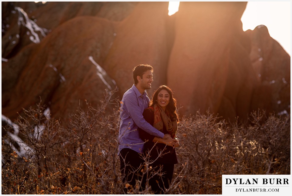 roxborough state park engagement photo session laughing indian couple at sunset in nature