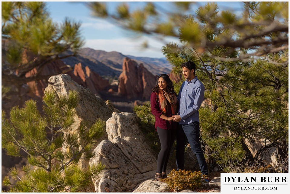 roxborough state park engagement photo session indian couple looking out at rock valley