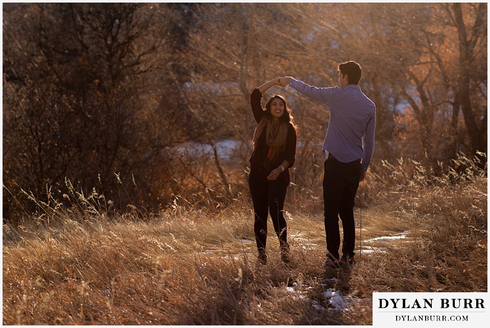 roxborough state park engagement photo session dancing in tall grass in fall