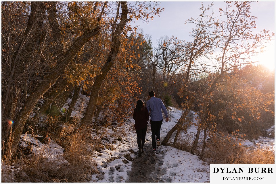 roxborough state park engagement photo session couple walking down a snowy path