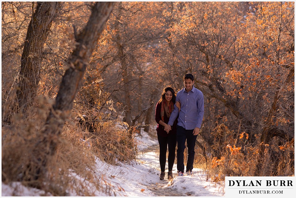 roxborough state park engagement photo session couple walking along a snowy path