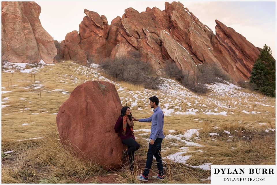 roxborough state park engagement photo session he comes up to her near a large rock