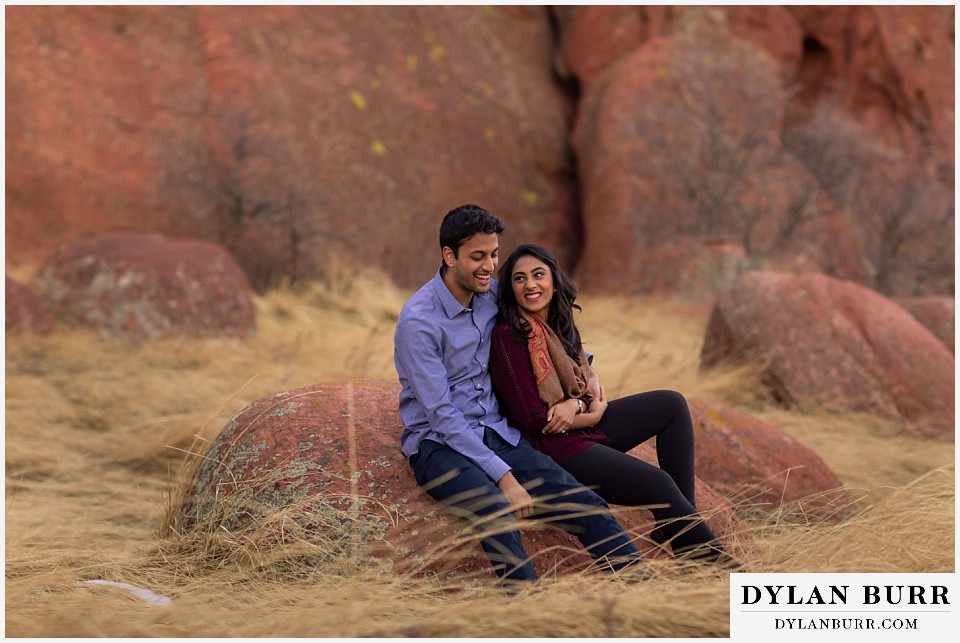 roxborough state park engagement photo session couple on rock and hes laughing at her jokes