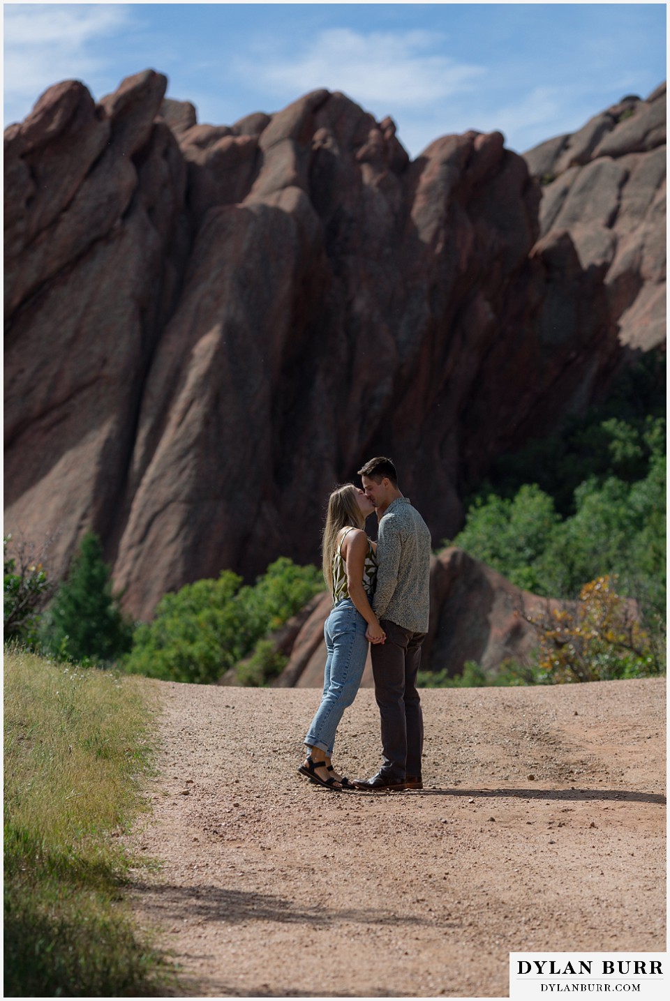 proposal in roxborough state park kisses on the path with red rocks in background