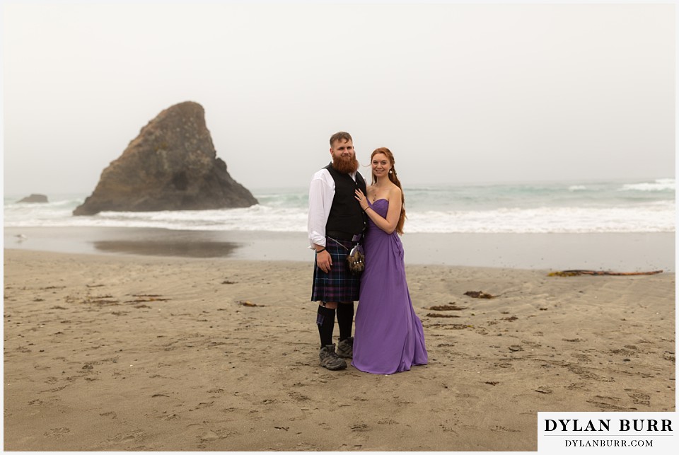 santa cruz california elopement wedding adventure maid of honor and best man with sharkfin rock in background at beach