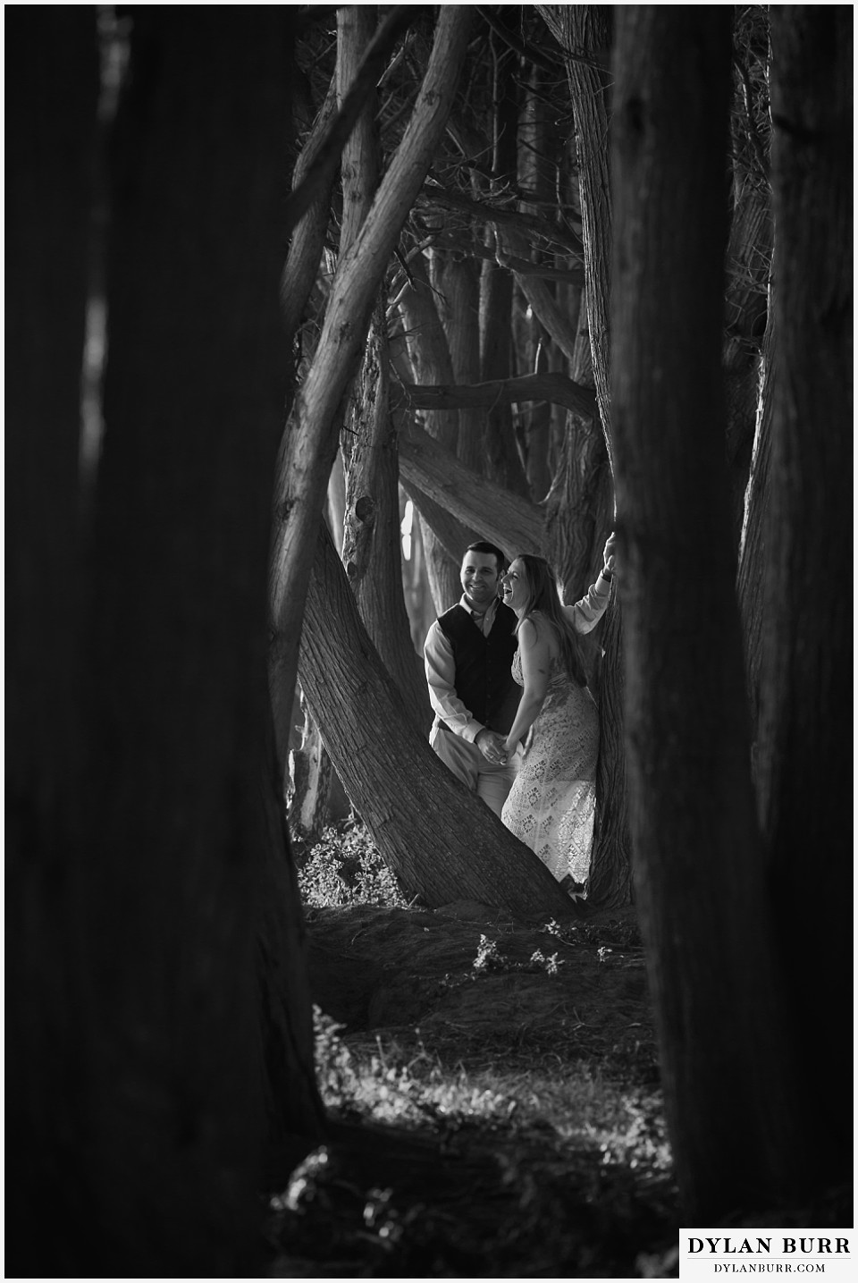 santa cruz california elopement wedding adventure bride and groom in cypress trees laughing together