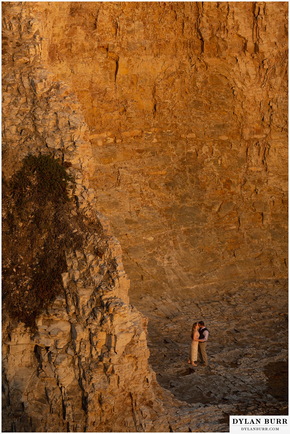 santa cruz california elopement wedding adventure bride and groom as base of cliffs at sunset